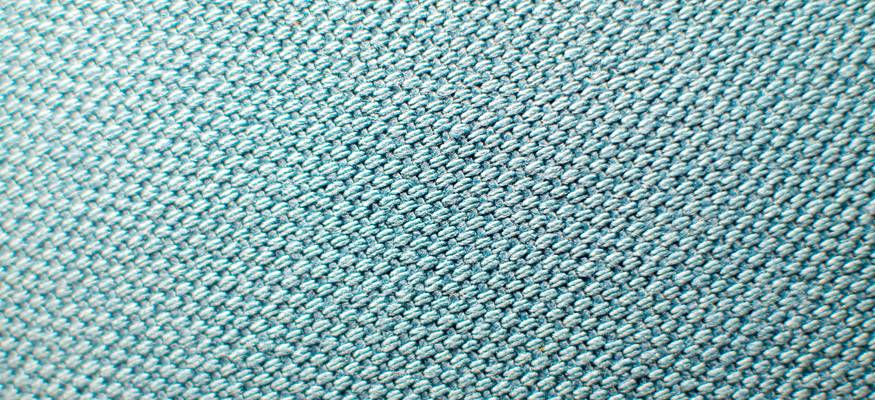 Close-up of mold growth on car fabric seat being cleaned