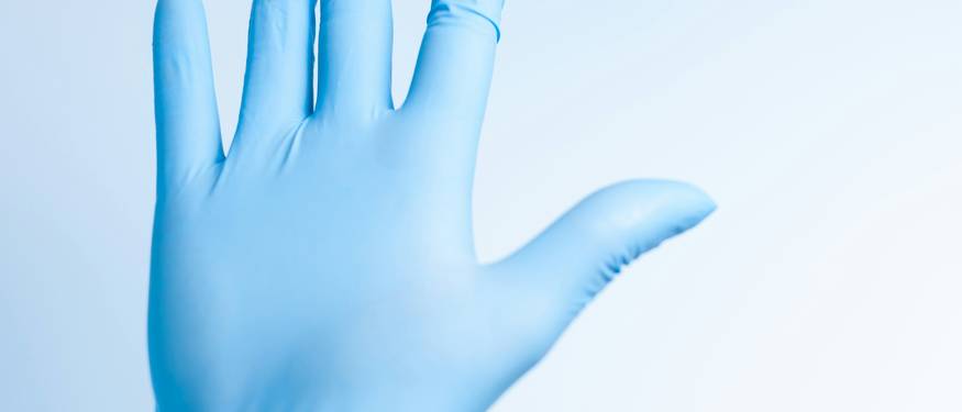 A selection of cleaning products, HEPA vacuum, gloves, and safety gear used for mold remediation