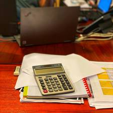 A stack of insurance policies and paperwork on a table